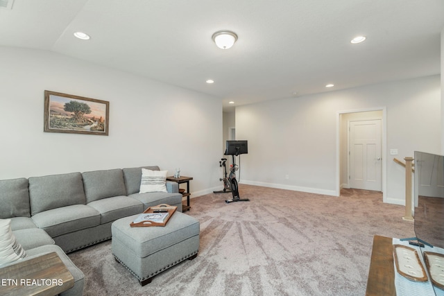 carpeted living area featuring baseboards and recessed lighting