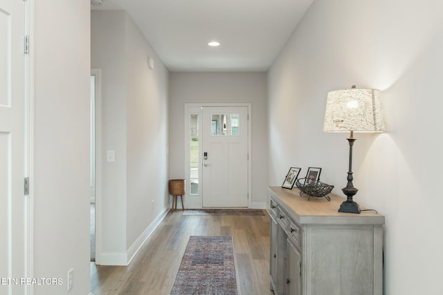 foyer entrance featuring light wood finished floors, recessed lighting, and baseboards