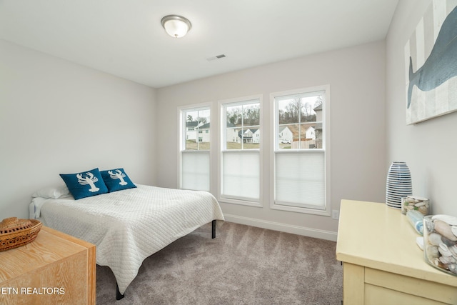 carpeted bedroom featuring visible vents and baseboards