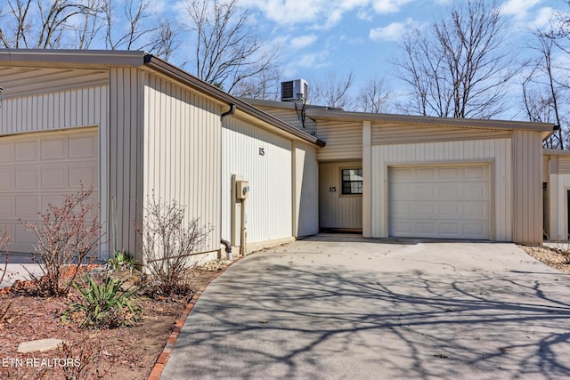 garage featuring cooling unit and driveway