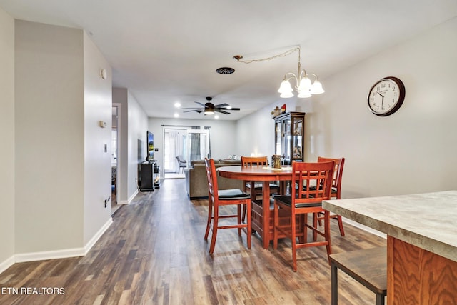 dining room featuring recessed lighting, baseboards, dark wood-style floors, and ceiling fan with notable chandelier