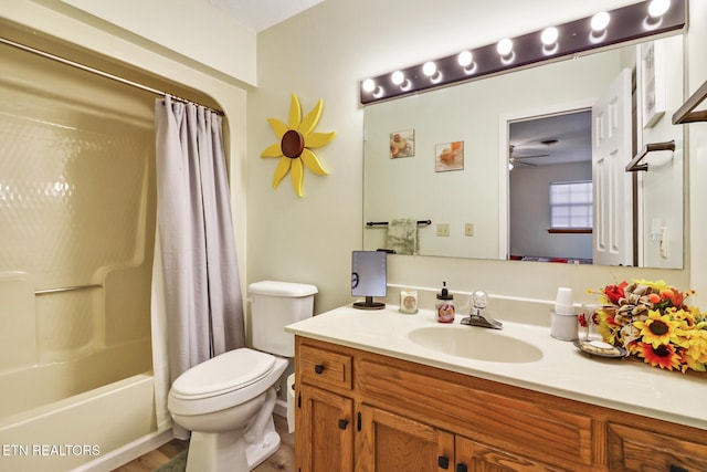 bathroom with ceiling fan, toilet, shower / bath combo, and vanity