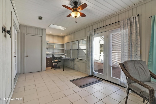 office area featuring light tile patterned floors, a skylight, and ceiling fan