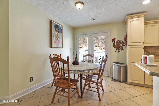 dining area featuring french doors, visible vents, baseboards, and light tile patterned floors