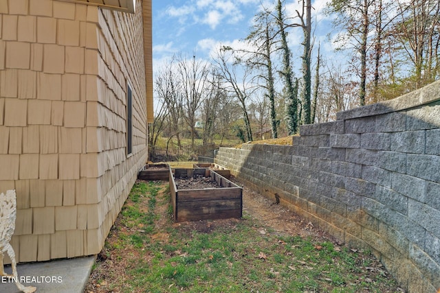 view of yard featuring a vegetable garden and fence