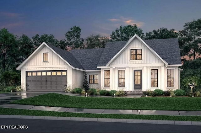 modern farmhouse featuring a shingled roof, concrete driveway, a front lawn, and an attached garage