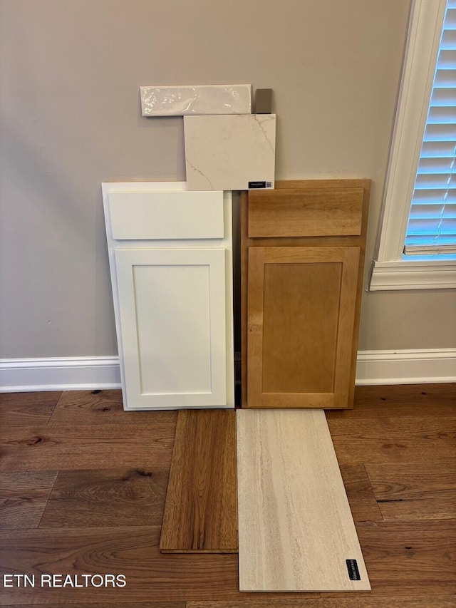 interior details featuring baseboards and wood finished floors