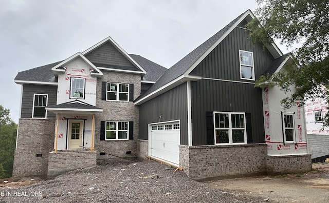 view of front of property featuring a shingled roof, an attached garage, crawl space, and brick siding
