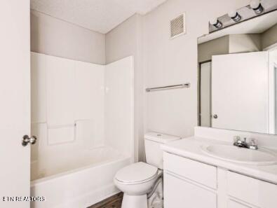 full bath with visible vents, toilet, bathtub / shower combination, wood finished floors, and vanity