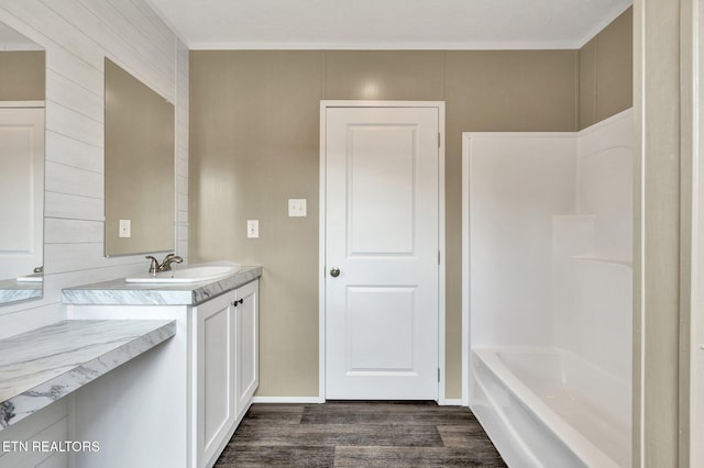 full bathroom featuring wood finished floors and vanity
