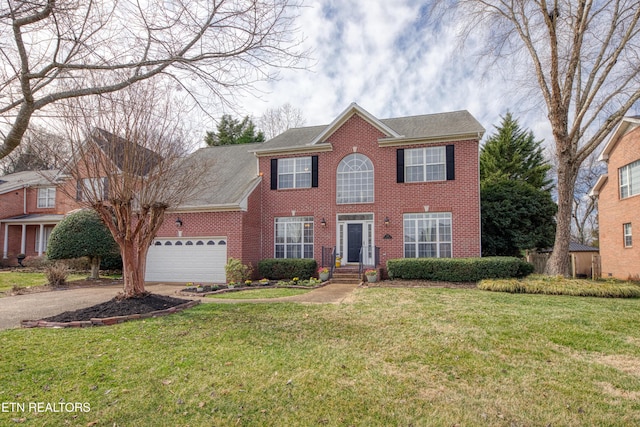 colonial house featuring brick siding, roof with shingles, a garage, driveway, and a front lawn