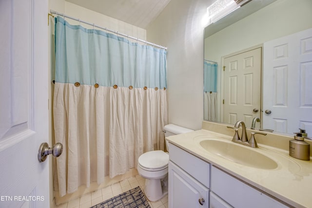 bathroom with a shower with curtain, vanity, toilet, and tile patterned floors