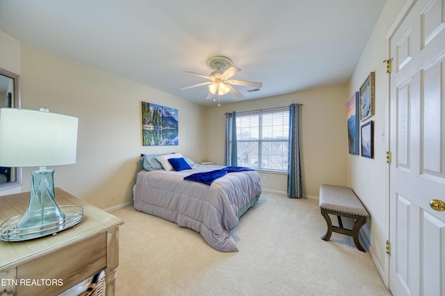 bedroom with light carpet, baseboards, visible vents, and a ceiling fan