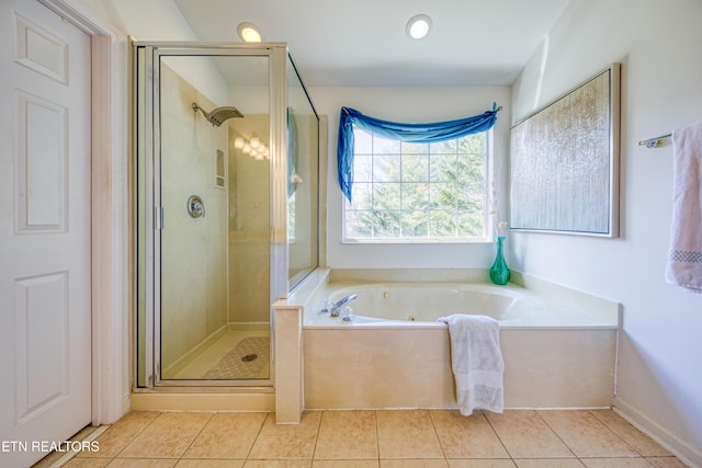 full bath featuring a jetted tub, a shower stall, and tile patterned floors