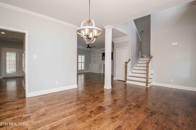 interior space with baseboards, stairway, wood-type flooring, and ornate columns