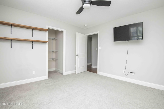 unfurnished bedroom with a ceiling fan, baseboards, a closet, and light colored carpet