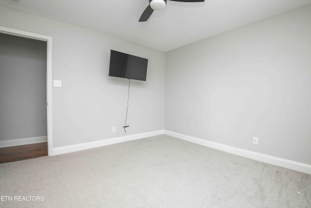 interior space featuring carpet, baseboards, and ceiling fan