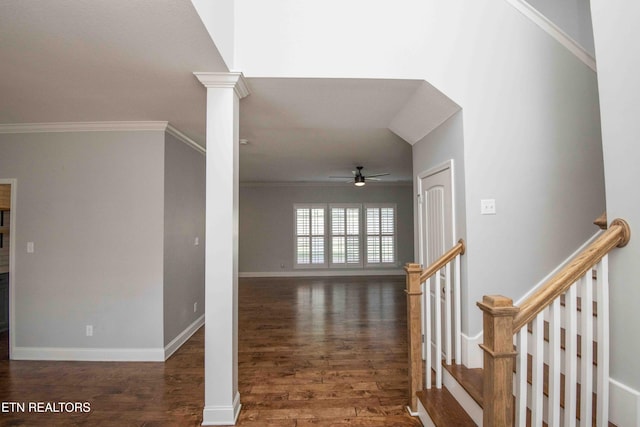 hall with ornamental molding, ornate columns, baseboards, and wood finished floors