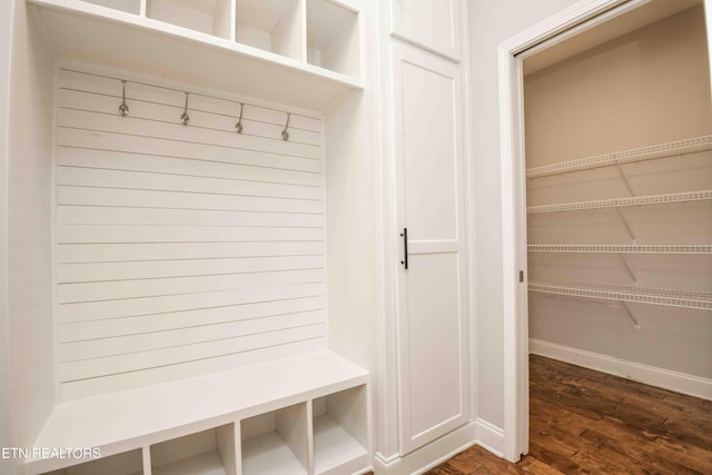 mudroom featuring dark wood-style floors and baseboards