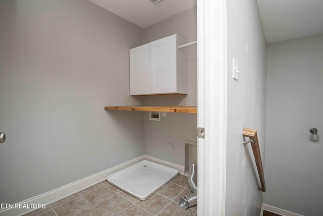 washroom with cabinet space, baseboards, hookup for a gas dryer, and washer hookup