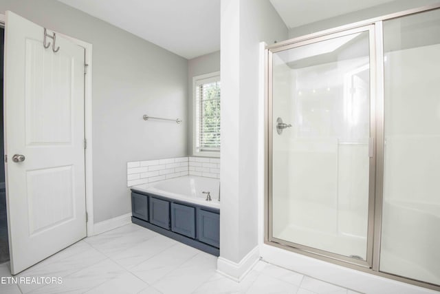 full bath with a stall shower, baseboards, marble finish floor, and a garden tub