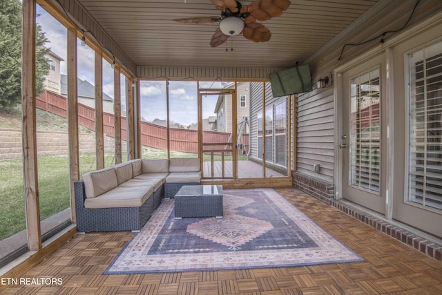 unfurnished sunroom with a ceiling fan