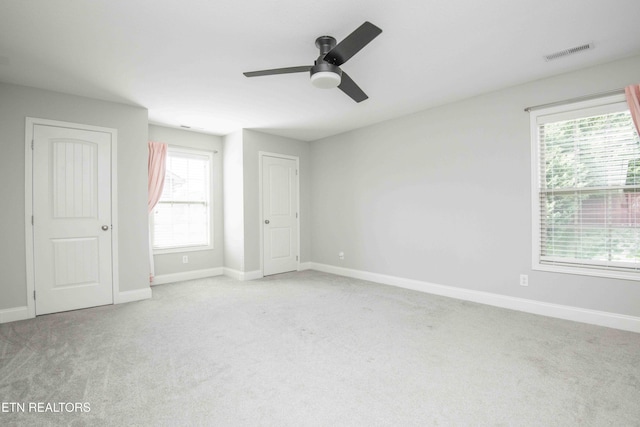 spare room with baseboards, visible vents, and carpet flooring