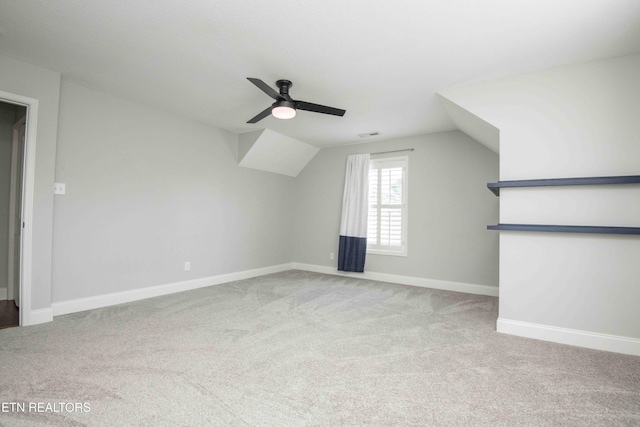 bonus room with a ceiling fan, baseboards, vaulted ceiling, and carpet flooring