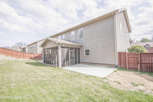 rear view of property featuring a sunroom, a fenced backyard, a patio area, and a yard