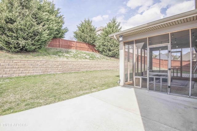 view of yard with a sunroom, a patio area, and fence