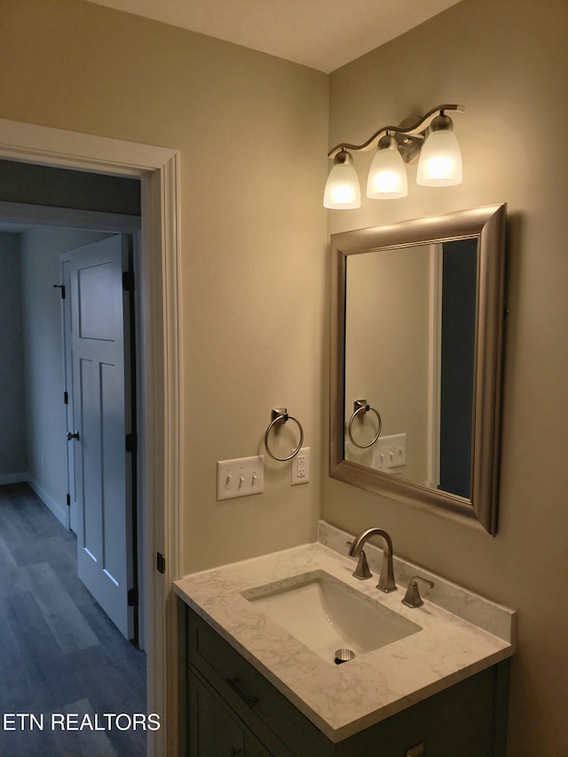 bathroom with vanity and wood finished floors