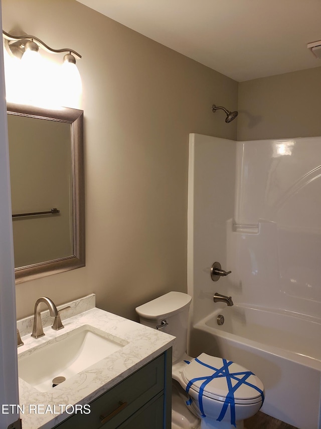 full bathroom featuring toilet, shower / washtub combination, and vanity