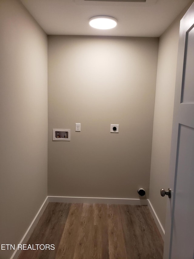 clothes washing area with hookup for a washing machine, hookup for an electric dryer, laundry area, wood finished floors, and baseboards