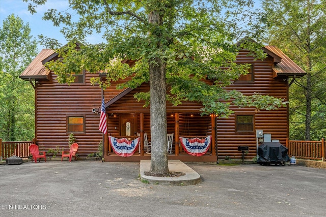 view of front of home featuring faux log siding