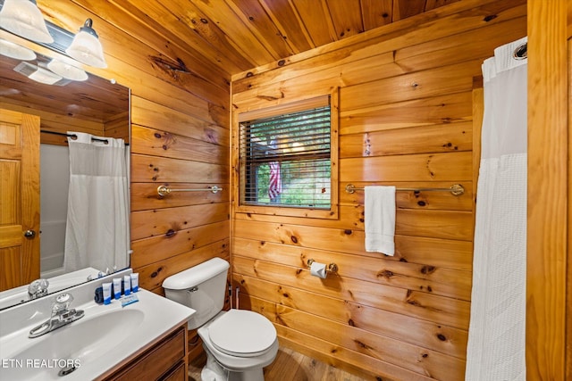 bathroom with toilet, a shower with curtain, wooden ceiling, vanity, and wood walls