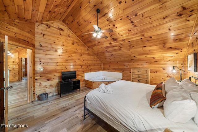 bedroom with vaulted ceiling, wooden ceiling, light wood-style flooring, and wooden walls