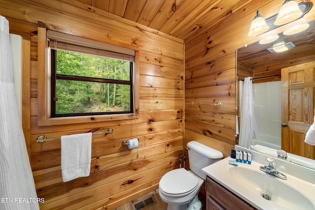 full bath with curtained shower, toilet, wood walls, vanity, and visible vents