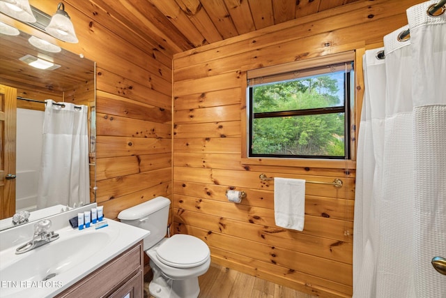 bathroom with a shower with curtain, vanity, wood ceiling, and wooden walls