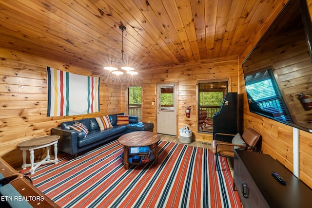 living area with wood walls, wood ceiling, and a notable chandelier