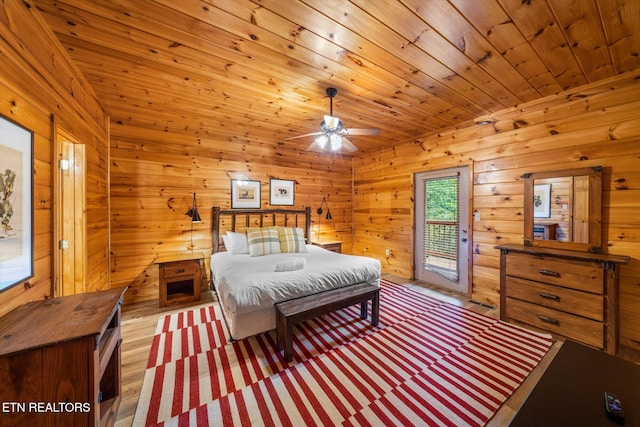 bedroom featuring access to exterior, wooden ceiling, and wood finished floors