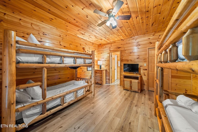 bedroom with wood ceiling, wood-type flooring, and wood walls