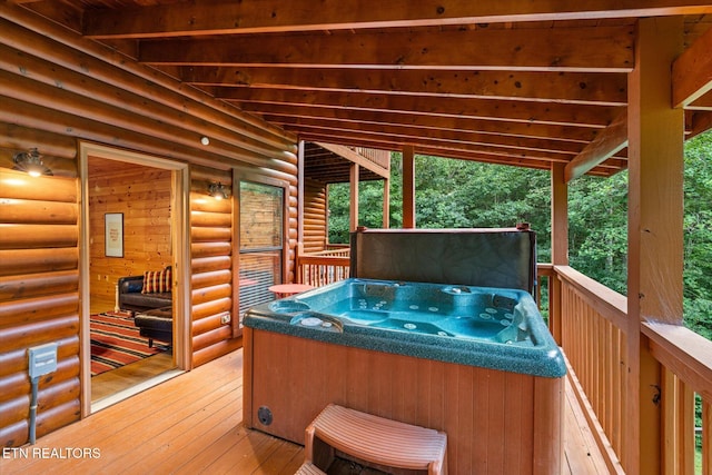 wooden deck with a hot tub