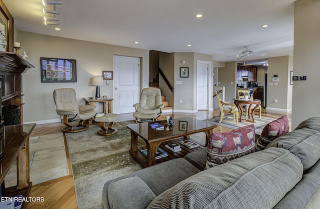 living room featuring light wood-style floors, baseboards, stairway, and recessed lighting