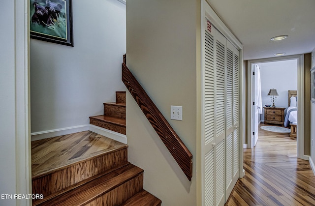 stairway with baseboards and wood finished floors