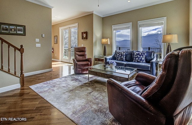 living room with baseboards, plenty of natural light, stairway, and wood finished floors