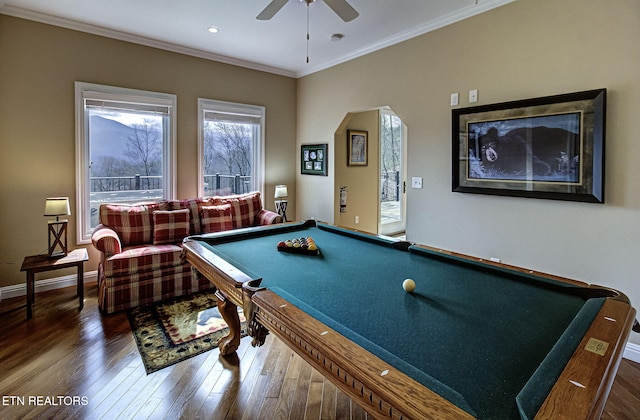 playroom with baseboards, arched walkways, a ceiling fan, hardwood / wood-style flooring, and crown molding