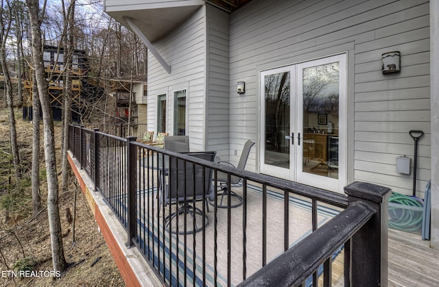 wooden terrace featuring french doors and wine cooler