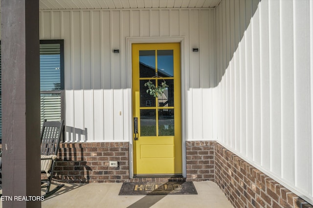 property entrance featuring brick siding