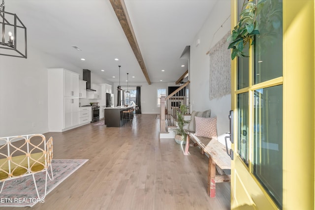 interior space with recessed lighting, light wood-type flooring, beamed ceiling, and stairway