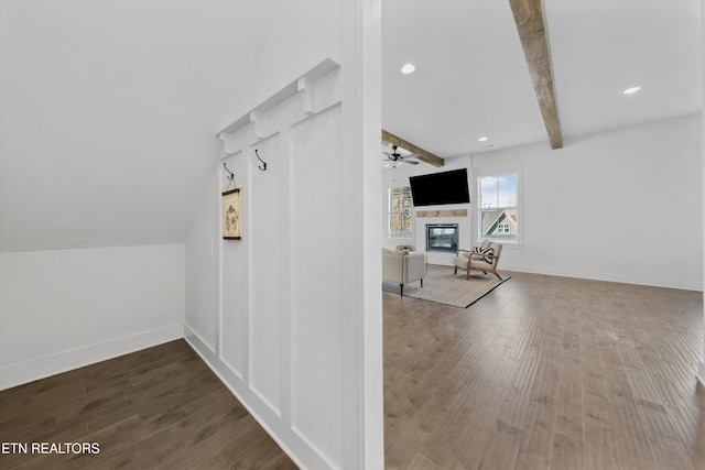 bonus room with a glass covered fireplace, vaulted ceiling with beams, baseboards, and wood finished floors